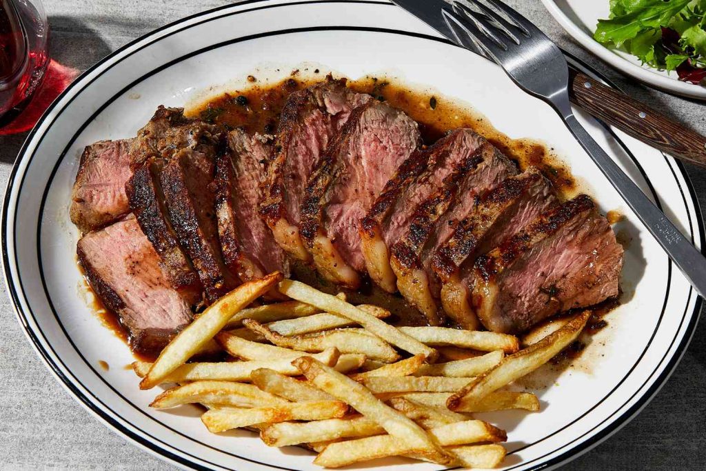 Ribeye Steak with Caramelized Onions and Fries